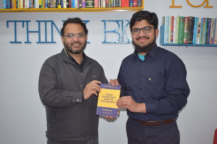 Presenting the book to Abid Iqbal Khari