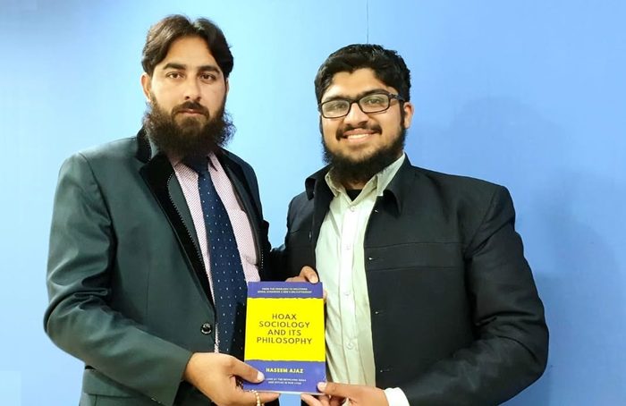 Presenting the book to Dr. Muhammad Azam Raza Tabassum