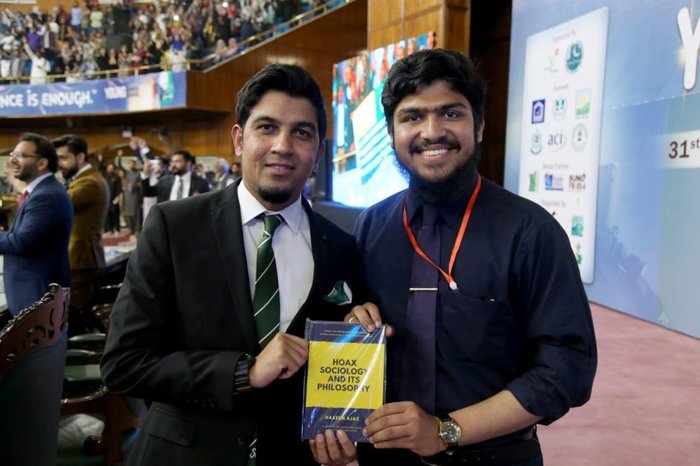 Presenting the book to Dr. Khurram Ellahi