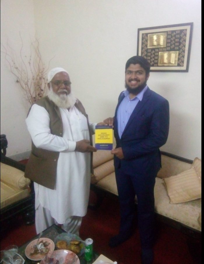 Presenting the book to Raja Noor Muhammad Nizami